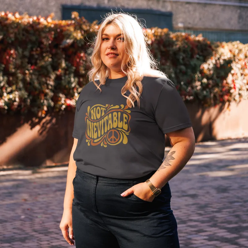 Anthracite Not Inevitable Peace Retro Tee, front view — bold 70s psychedelic lettering reading Not Inevitable with a peace