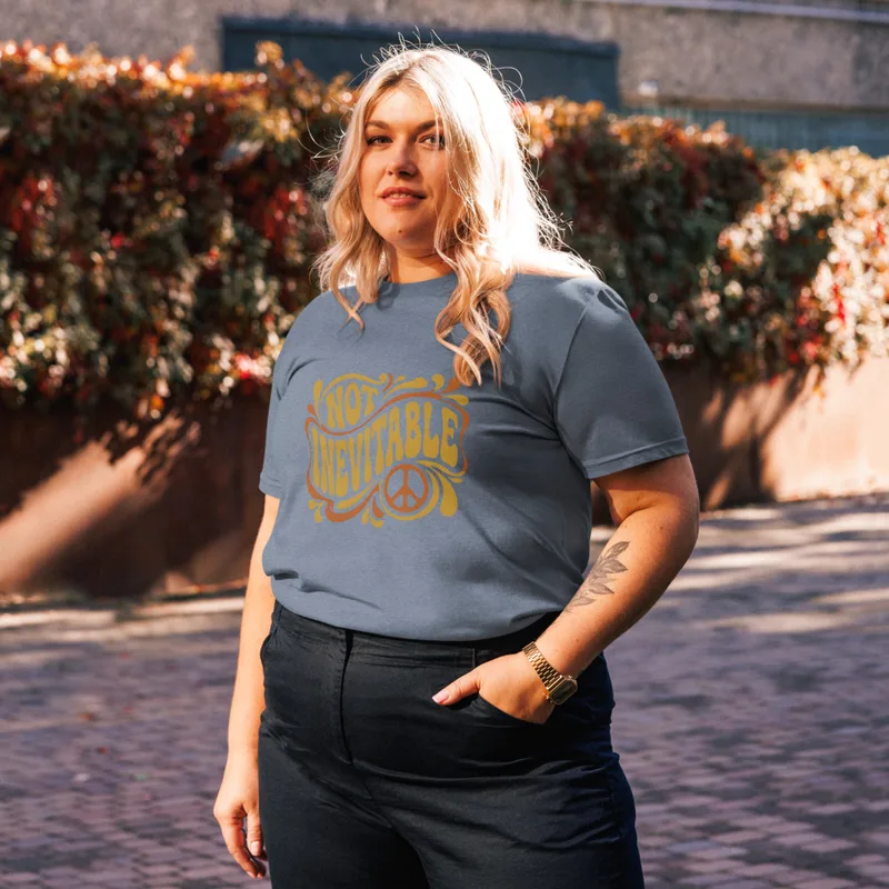 Dark Heather Blue Not Inevitable Peace Retro Tee, front view — bold 70s psychedelic lettering reading Not Inevitable