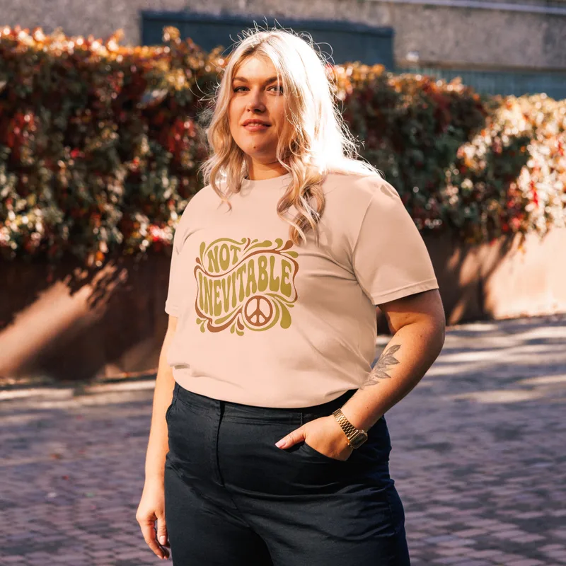 Fraiche Peche Not Inevitable Peace Retro Tee, front view — bold 70s psychedelic lettering reading Not Inevitable