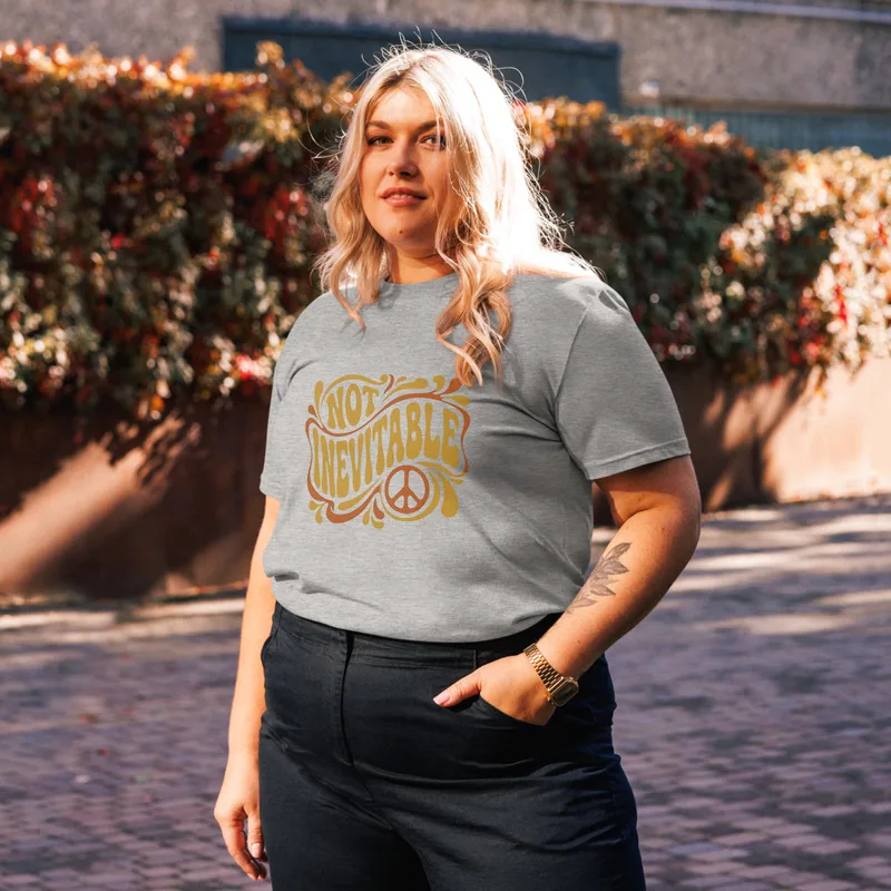 Heather Grey Not Inevitable Peace Retro Tee, front view — bold 70s psychedelic lettering reading Not Inevitable with a peace