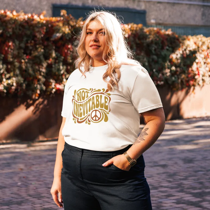 White Not Inevitable Peace Retro Tee, front view — bold 70s psychedelic lettering reading Not Inevitable with a peace