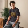 Anthracite Not Inevitable Peace Retro Tee, front view — bold 70s psychedelic lettering reading Not Inevitable with a peace