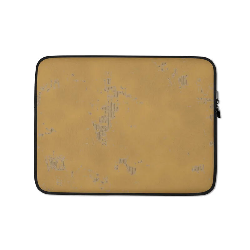 Desert Gold Weathered Patina Laptop Sleeve — warm amber and ochre surface with scattered silver-grey distressed flaking