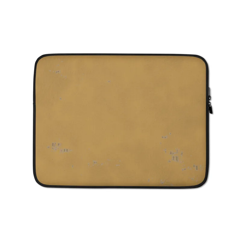 Desert Gold Worn Finish Laptop Sleeve — warm golden-ochre surface with subtle brushstroke texture and scattered worn patches