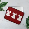 Triple Bell Holiday Laptop Sleeve — three white Christmas bells with ribbon bows arranged in a row on a deep red background