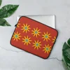Solar Burst Crimson Laptop Sleeve — repeating golden eight-petal sunburst flowers with blue centers arranged in rows