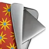 Solar Burst Crimson Laptop Sleeve — repeating golden eight-petal sunburst flowers with blue centers arranged in rows