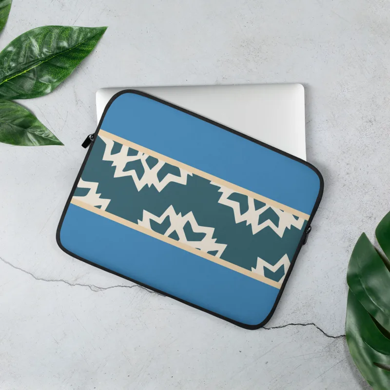 Arctic Fracture Laptop Sleeve — jagged cracked ice shards in cream white on deep teal horizontal band, framed by sand