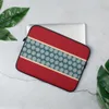 Crimson Band Snowflake Laptop Sleeve — deep red background with a horizontal teal band bordered in cream, filled