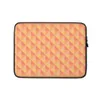 Warm Geometry Laptop Sleeve — tessellating triangles in coral red, golden yellow, and soft peach with a blurred vignette