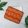 Ancient Waves Gold Spiral Laptop Sleeve — golden wave bands and concentric spiral motifs arranged in rows on a deep crimson