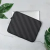 Carbon Weave Shadow Laptop Sleeve — seamless woven carbon fiber pattern with interlocking diagonal bands in deep charcoal