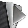 Carbon Weave Shadow Laptop Sleeve — seamless woven carbon fiber pattern with interlocking diagonal bands in deep charcoal