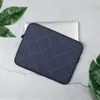 Navy Diamond Quilted Laptop Sleeve — navy blue textured fabric with white dashed diagonal diamond grid and small cross