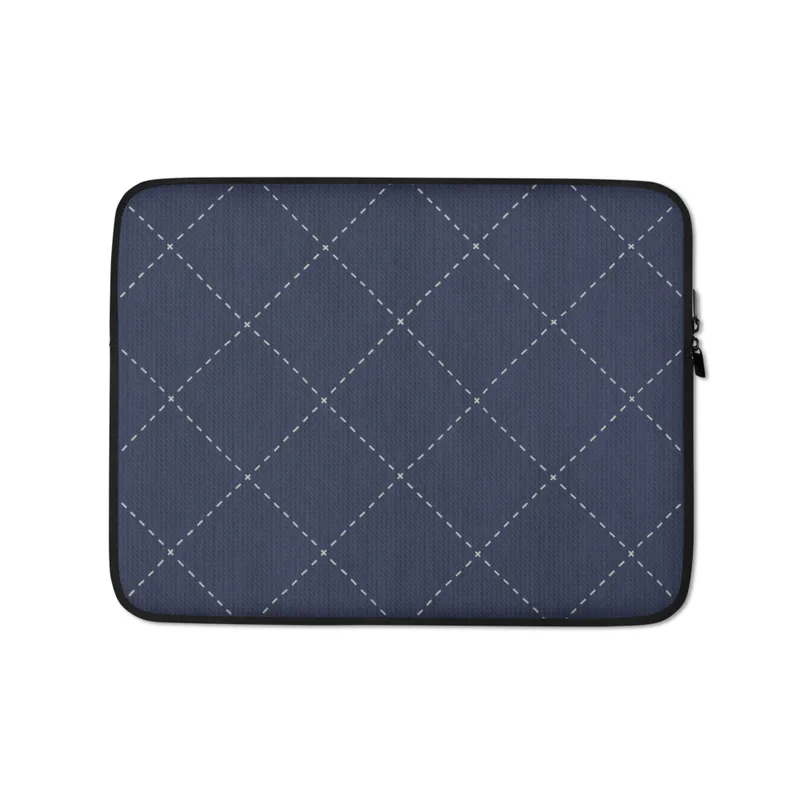 Navy Diamond Quilted Laptop Sleeve — navy blue textured fabric with white dashed diagonal diamond grid and small cross