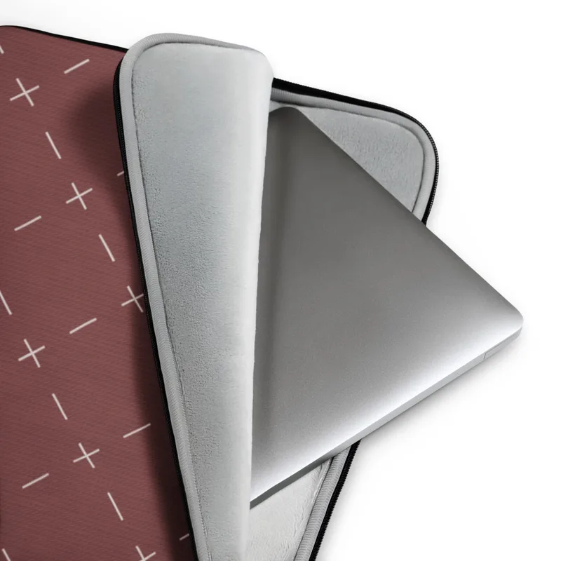 Crimson Cross Stitch Laptop Sleeve — repeating white cross and dash stitch motifs scattered across a rich burgundy textured