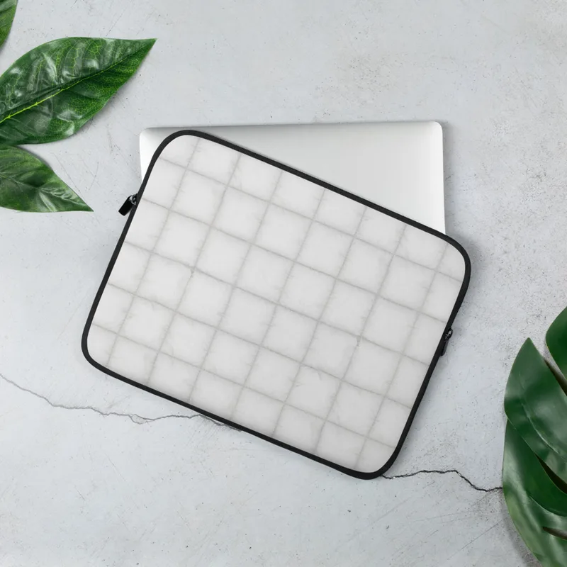 Cloud White Quilted Laptop Sleeve — soft white quilted grid pattern with subtle stitched seams and a plush pillow-like