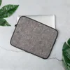 Urban Felt Grey Laptop Sleeve — close-up photograph of grey industrial felt with tangled fibers and scattered colorful