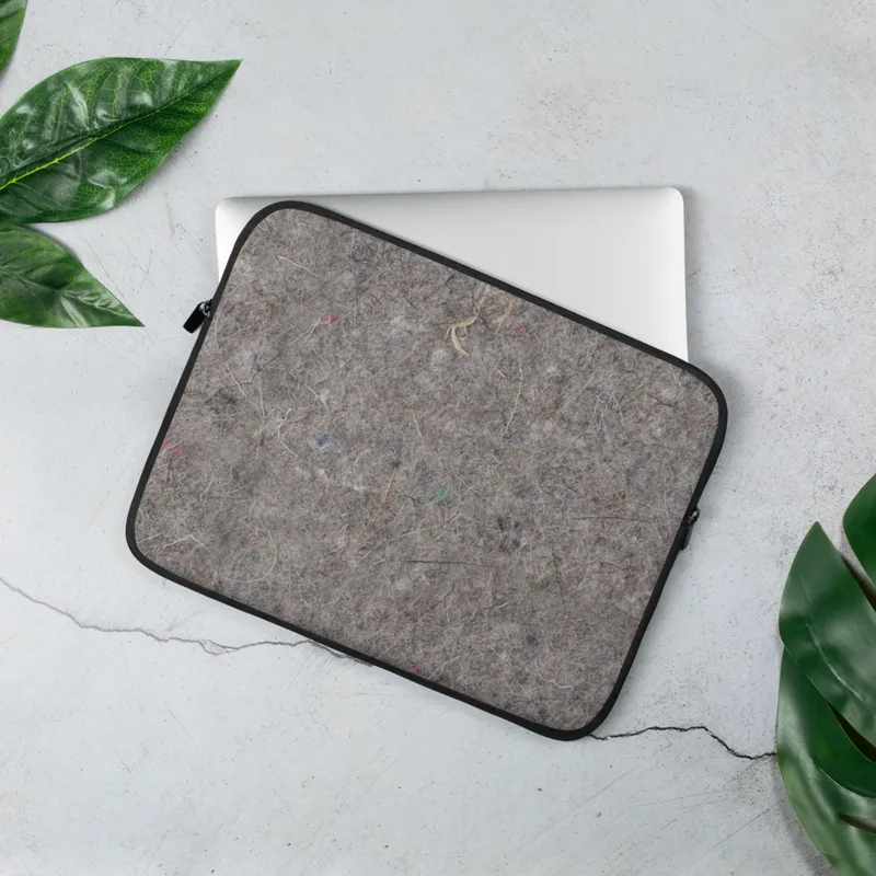 Urban Felt Grey Laptop Sleeve — close-up photograph of grey industrial felt with tangled fibers and scattered colorful
