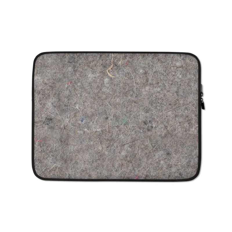Urban Felt Grey Laptop Sleeve — close-up photograph of grey industrial felt with tangled fibers and scattered colorful