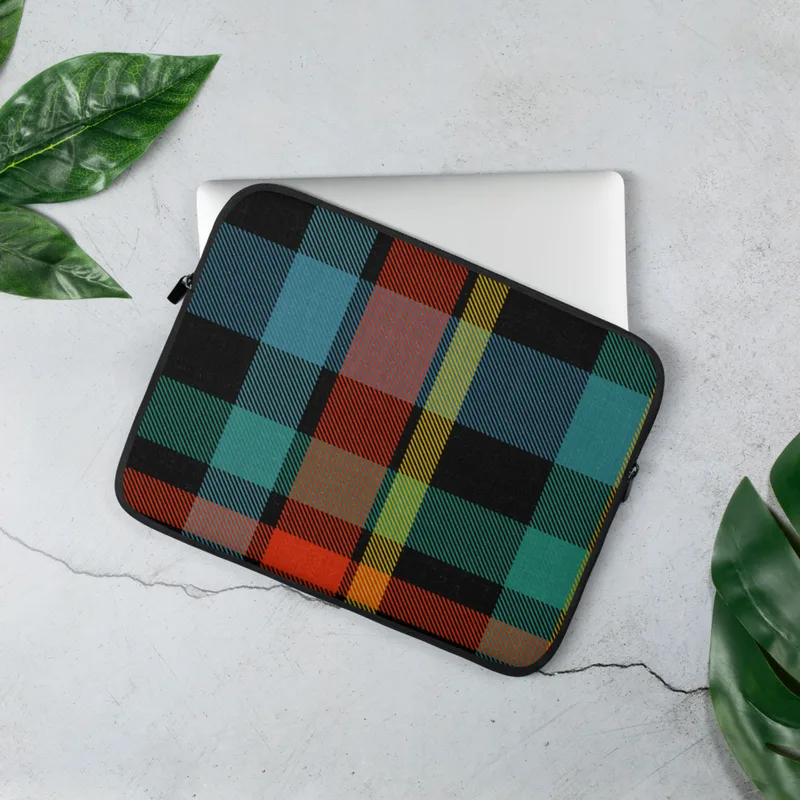 Bold Highland Plaid Laptop Sleeve — vibrant tartan plaid pattern with intersecting bands of black, teal, fiery orange-red