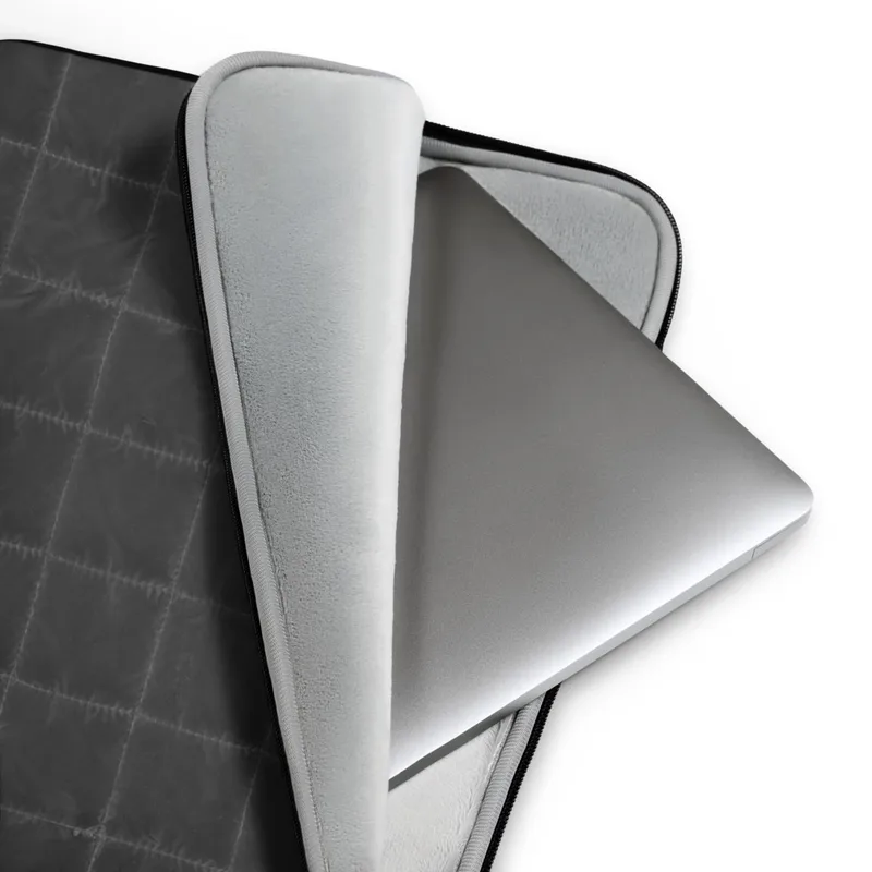 Midnight Grid Quilted Laptop Sleeve — close-up quilted grid pattern in deep charcoal with stitched seams forming uniform