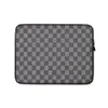 Charcoal Flannel Check Laptop Sleeve — close-up woven check pattern in charcoal and light grey with diagonal twill texture