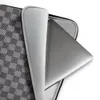 Charcoal Flannel Check Laptop Sleeve — close-up woven check pattern in charcoal and light grey with diagonal twill texture