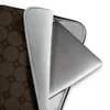 Dark Cobblestone Grid Laptop Sleeve — repeating grid of dark octagonal stone tiles with small diamond joints in deep