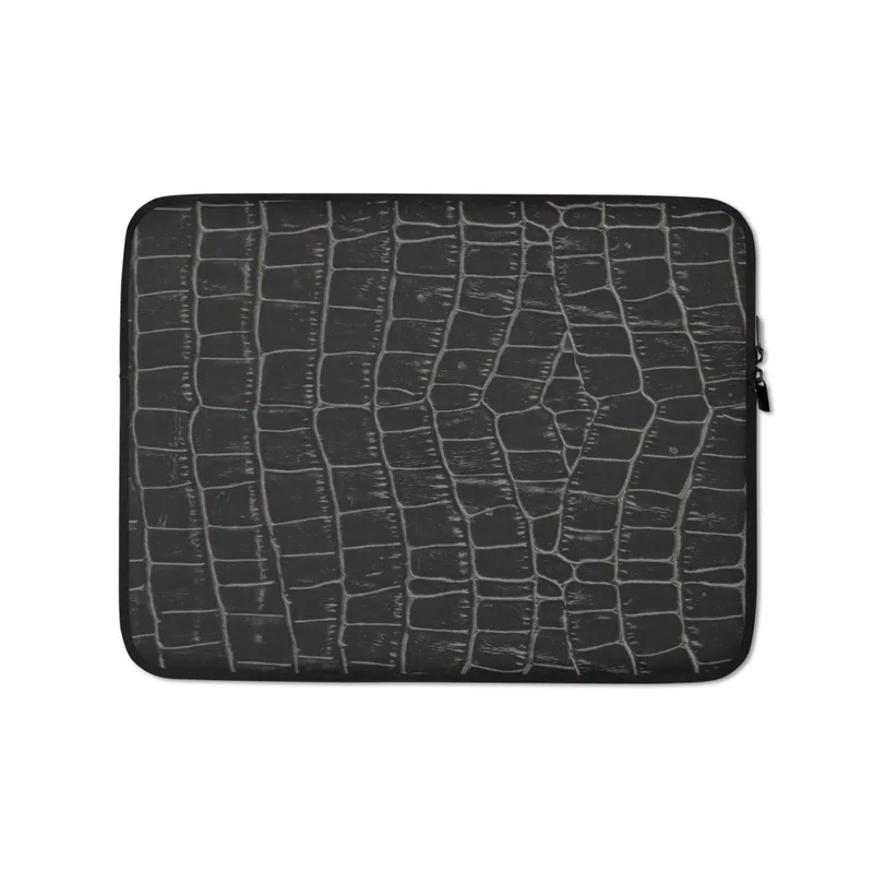 Midnight Croc Laptop Sleeve — close-up crocodile skin emboss pattern in deep black with raised segmented scales and grey