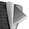 Midnight Croc Laptop Sleeve — close-up crocodile skin emboss pattern in deep black with raised segmented scales and grey