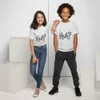 Ash Huh? Say That Again, front view — bold hand-lettered word Huh followed by a question mark in dark navy blue on a warm