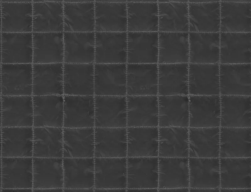 Midnight Grid Quilted Laptop Sleeve design — close-up quilted grid pattern in deep charcoal with stitched seams forming