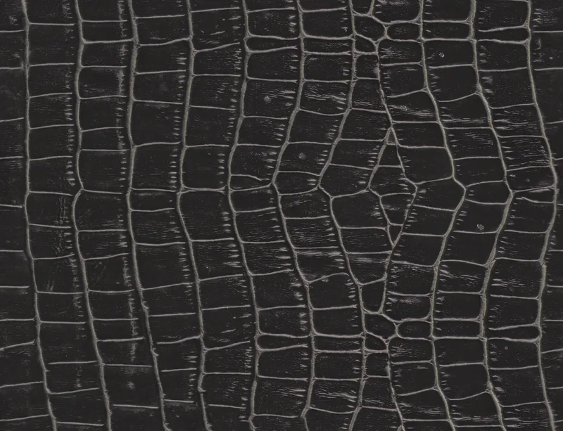 Midnight Croc Laptop Sleeve design — close-up crocodile skin emboss pattern in deep black with raised segmented scales