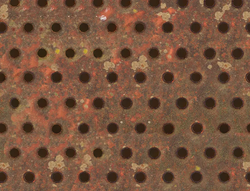 Industrial Rust Perforated Metal Laptop Sleeve design — heavily rusted perforated metal plate with dark circular holes