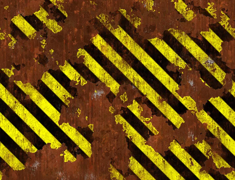 Hazard Zone Rust Warning Laptop Sleeve design — diagonal yellow and black hazard stripes over heavily rusted corroded metal