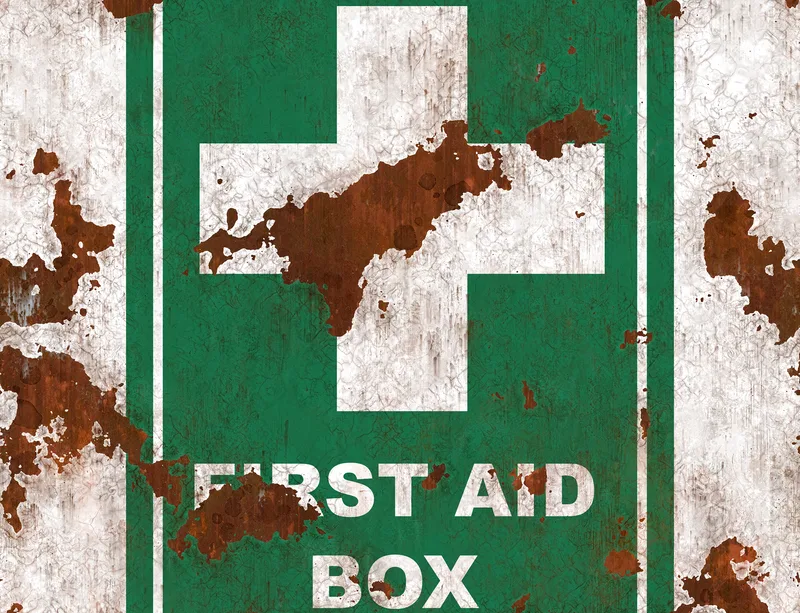 Rusted First Aid Survivor Laptop Sleeve design — weathered teal green first aid box sign with white cross, heavily